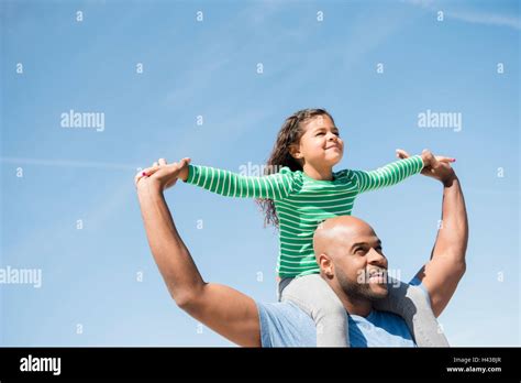 Father Carrying Daughter On Shoulders Stock Photo Alamy