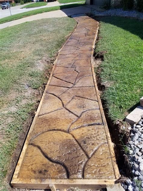 A Wooden Walkway In The Middle Of A Yard