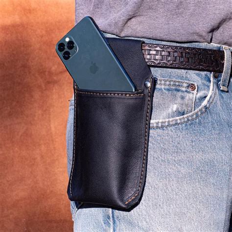 A Cell Phone In A Black Leather Pouch On Someone S Back Pocket With