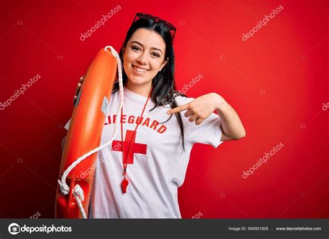 Young Lifeguard Woman Wearing Secury Guard Equipent Holding Rescue