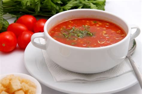 Premium Photo Tomato Soup With Crackers And Herbs