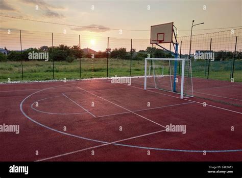 Outdoors mini football and basketball court with ball gate and basket surrounded with high ...