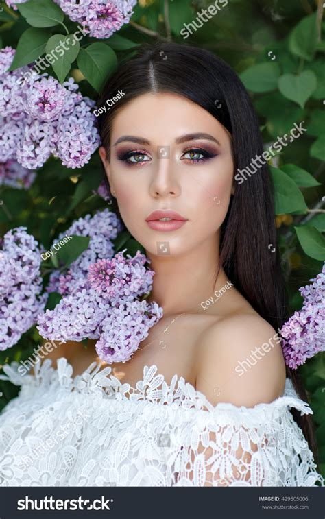 Portrait Of Beautiful Sensual Brunette Girl In White Dress In Lilac