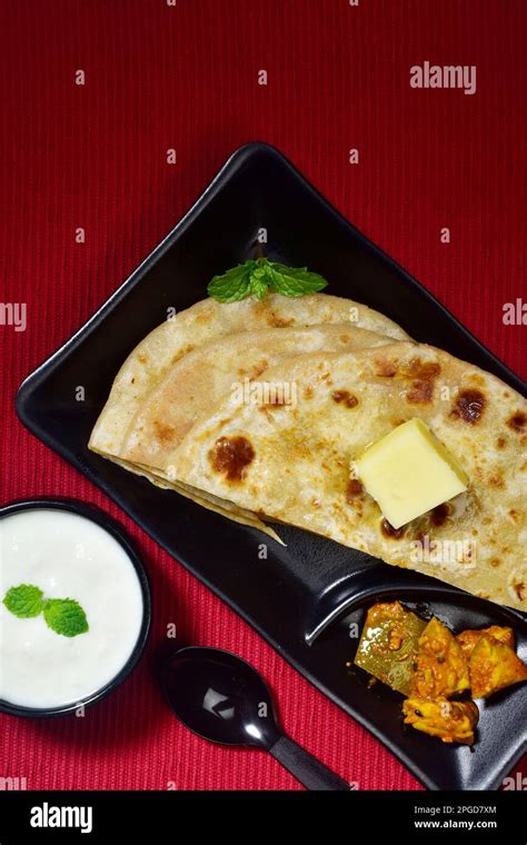 Top view of butter paratha with curd and aachar Stock Photo - Alamy