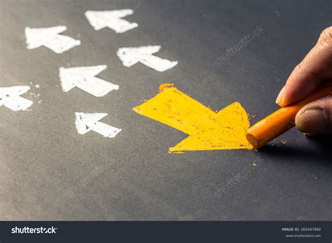 Hand Drawing Arrow Sign In Opposite Direction From Others Stock Photo