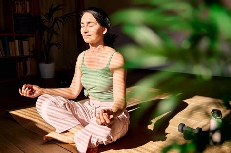 Premium Photo Woman Practicing Yoga And Meditation At Home Sitting In