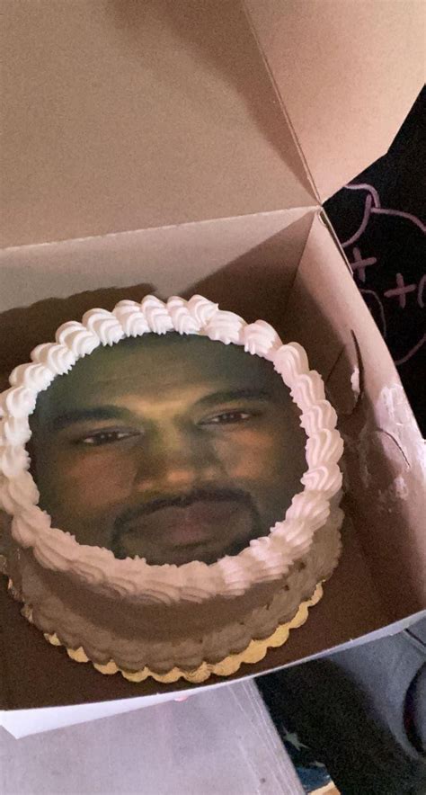 A Man S Face Is Shown On Top Of A Cake In A Box