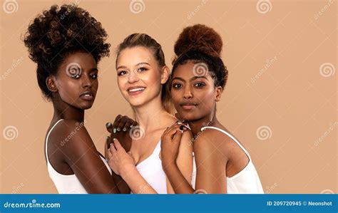 Three Beautiful Multi Ethnic Women Posing Together Looking At Camera