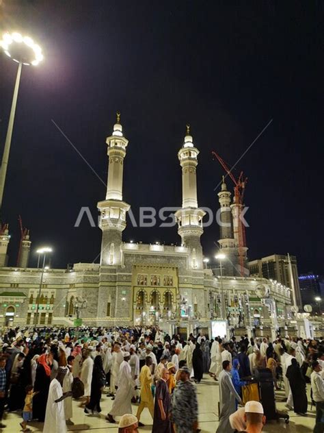 Pilgrims And Umrah Gather In The Outer Courtyard Of The Holy Mosque Of