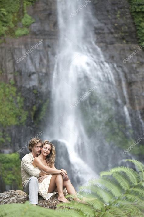 Couple Hugging By Waterfalls — Stock Photo © Mjth 21103527