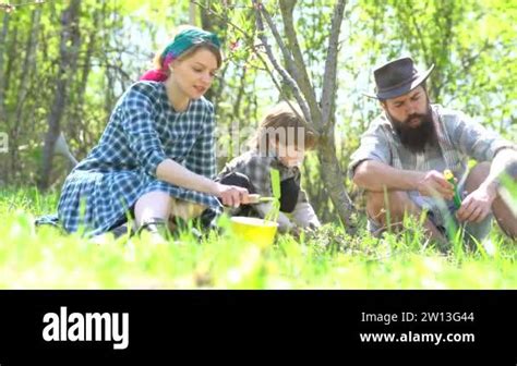 Farmers family watering the sprout on field. Country life - Eco farm ...