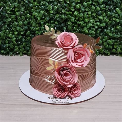 There Is A Chocolate Cake With Pink Flowers On It