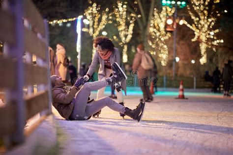 A Young Guy Falling Down At Skating At Ice Rink Skating Closeness