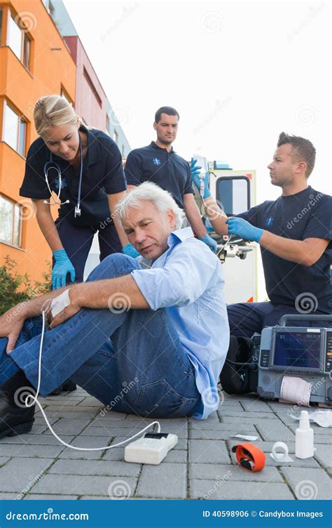 Paramedical Team Giving Firstaid To Injured Man Stock Photo Image Of