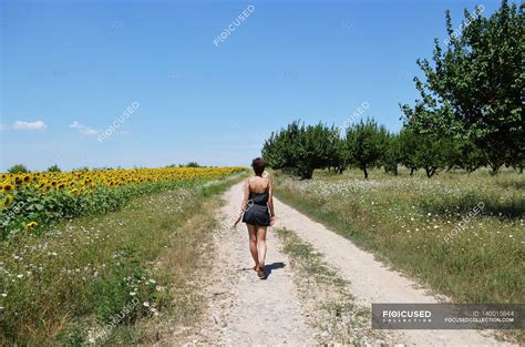young woman walking  path copy space young adult stock photo