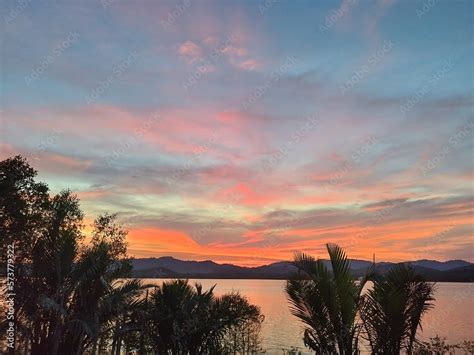 Sunset River View. Sunset sky. Vibrant beauty from sunset pictured with silhouette of mountain ...