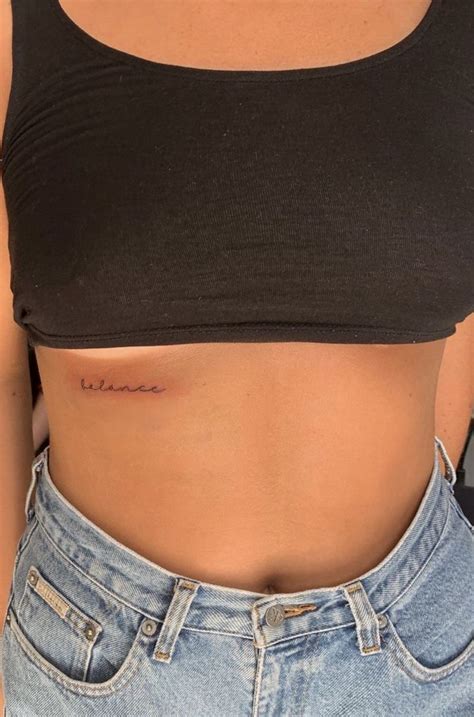 A Woman S Stomach With The Word Love Tattooed On It