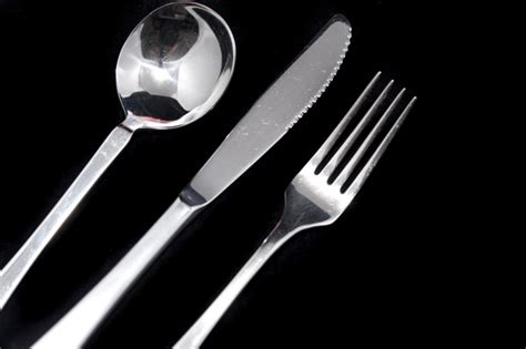 clean metal knife fork  spoon  black  stock image
