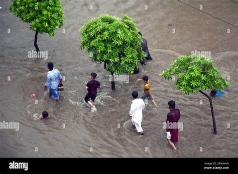 Lahore June People Wade Through Flood Water