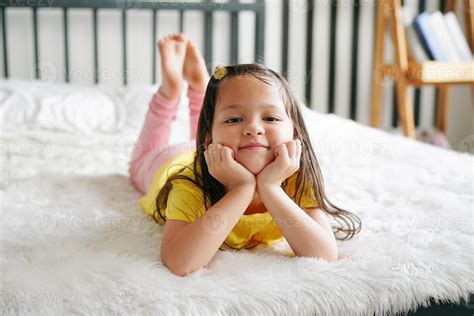 Little girl lying on bed and look at camera. 9814857 Stock Photo at ... 