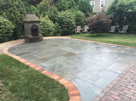 Dry Laid Natural Cleft Bluestone Patio With A Soldier Brick Border