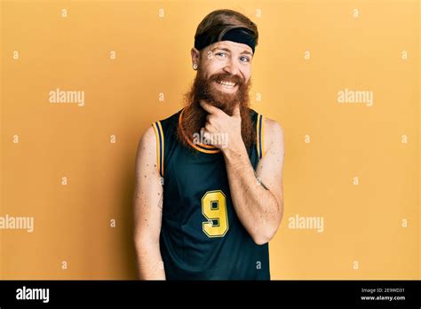 Redhead Man With Long Beard Wearing Basketball Uniform Looking