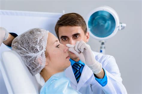 Plastic Surgery Doctor Patient Inspection And Consultation Stock Photo