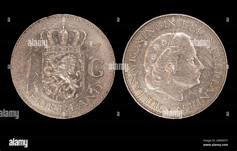 A Closeup Of Netherlands One Gulden Coins With Queen Juliana On A Dark