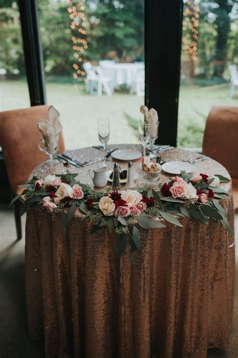 Sweetheart Table With Rose Gold Accents Roses And Eucalyptus