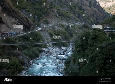 Nepalese Mountain Village By A Suspension Bridge Over The Marshyangdi