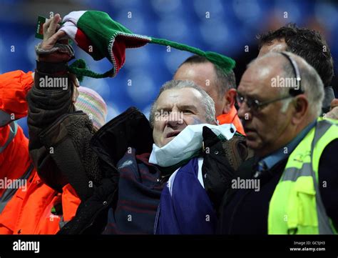 A Football Fan Who Invaded The Pitch Is Escorted Out Of The Stadium By