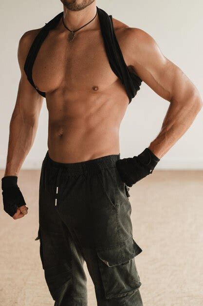 Premium Photo An Adult Muscular Man With A Naked Torso Stands In A