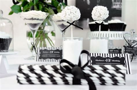 A Table Topped With Black And White Cupcakes