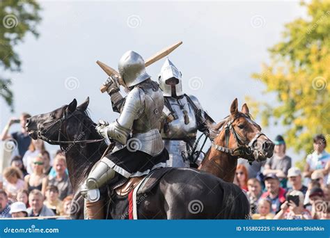 Two Men Knights Riding Horses On The Battlefield And Having A Fight On