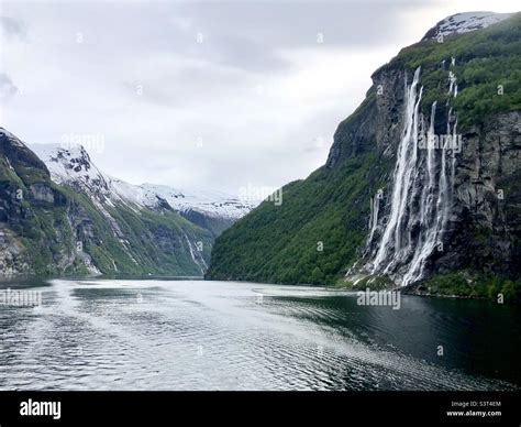 Norwegian fjords snow capped mountains Stock Photo - Alamy