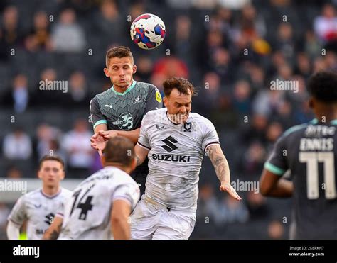 Plymouth Argyle Midfielder Jordan Houghton Battles In The Air With