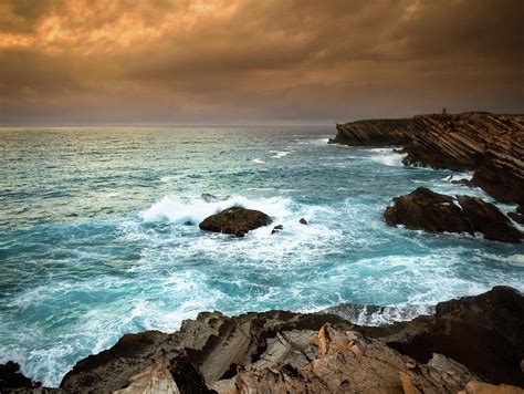 Cliff Over The Ocean At Sunset During A Photograph By Moreiso