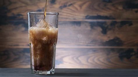 Pouring Cola With Ice Cubes Cola Soda With Bubbles Close Up Slow