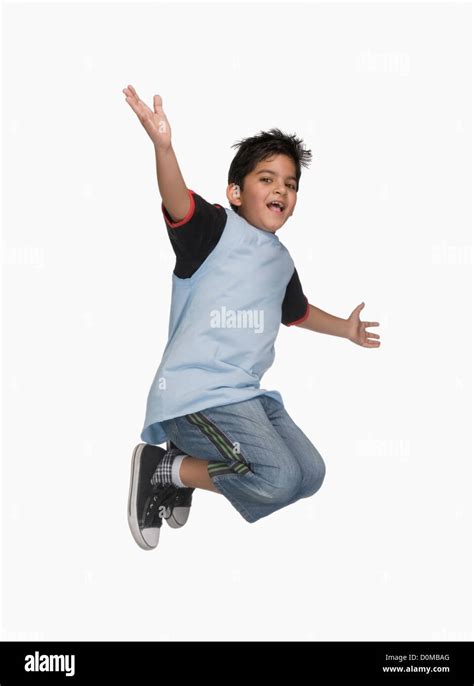 Boy Jumping In Air With His Arm Outstretched Stock Photo Alamy