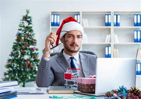 The Young Businessman Celebrating Christmas In The Office Young