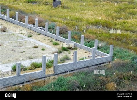 Concrete foundation of the future fence. Concrete fence, fence ...