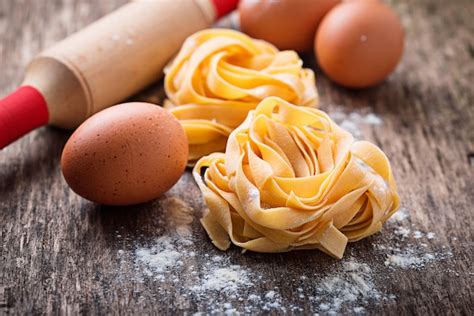 Premium Photo Raw Pasta Tagliatelle And Eggs