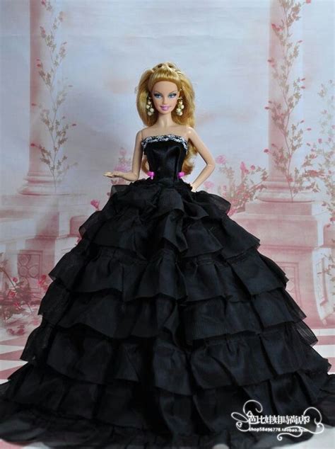 A Barbie Doll Dressed In A Black Dress