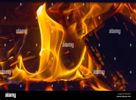 Logs burning in a log fire Stock Photo - Alamy