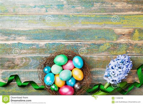 Painted Colorful Easter Eggs In Nest With Hyacinth Flowers And Ribbon