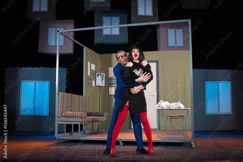 Actress Brunette Woman In A Sexual Way And A Man In A Blue Suit An Actor Playing The Role In