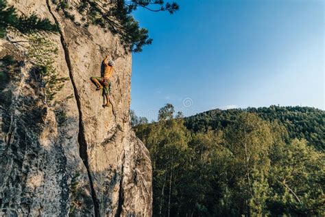 Mountain Climber Climbing the Cliff Using His Climbing Equipment ...