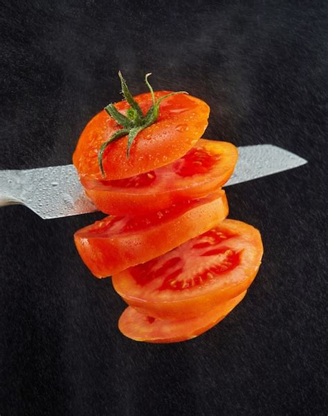 Premium Photo Levitation Of Fresh Cut Tomato A Knife Cuts Tomato In