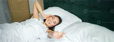 Romantic Asian Girl Wakes Up And Stretches Smiling Happily Reaching