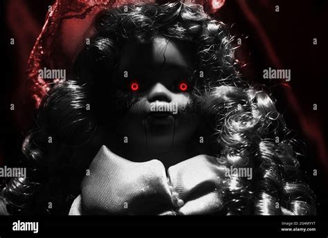 Horror Photo Of Scary Demon Possessed Plastic Doll With Glowing Red Eyes On Dark Background